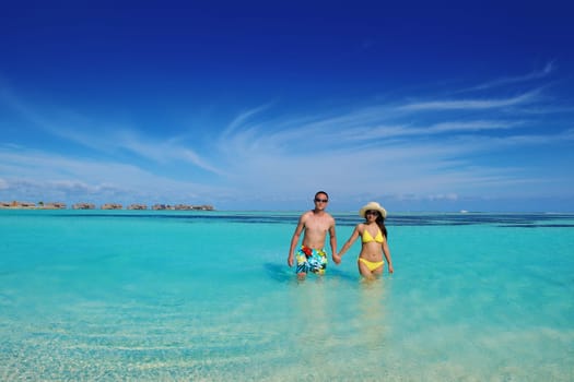 happy young asian couple have fun and romantic time at  summer on beautiful white sand beach