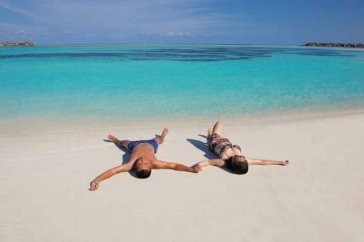 happy young asian couple have fun and romantic time at  summer on beautiful white sand beach