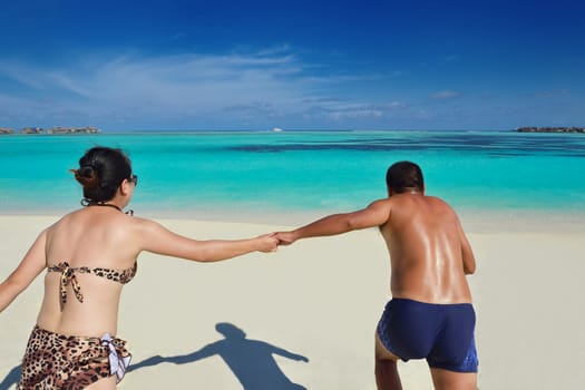 happy young asian couple have fun and romantic time at  summer on beautiful white sand beach