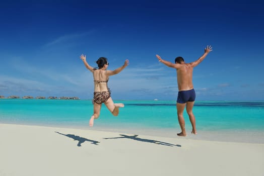 happy young asian couple have fun and romantic time at  summer on beautiful white sand beach