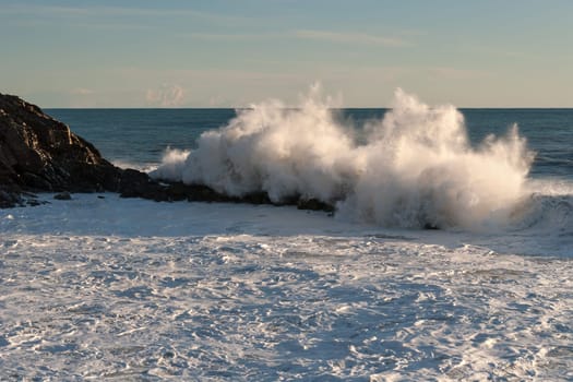 wave that breaks on the rocks in Genoa
