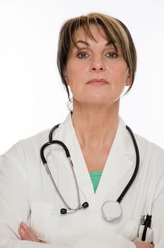 Side head and shoulders shot of a middle-aged doctor in a white coat and stethoscope placed around her neck looking at the camera against a white background