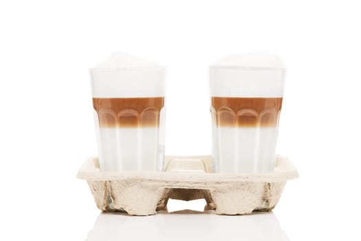 Latte macchiato to go in coffee holder on white background