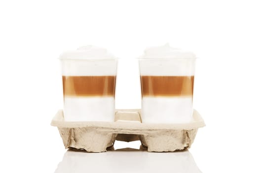 Two lattes macchiato coffee to go in plastic cups on white background