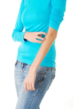 Young woman scratching her self. Isolated on white