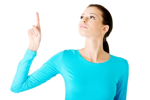 Happy , excited young woman pointing on copy space, isolated on white