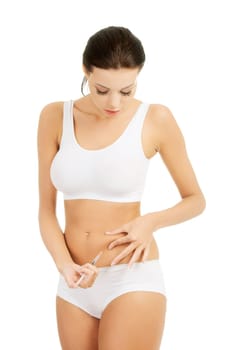 Diabetes woman patient make an abdomen subcutaneous syringe insulin injection with needle