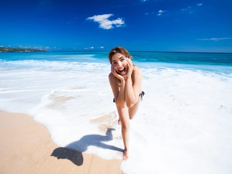 Beautiful and happy young woman  enjoying the summer on a tropical beach