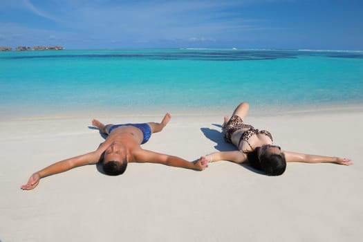 happy young asian couple have fun and romantic time at  summer on beautiful white sand beach