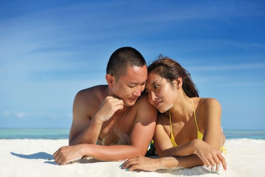happy young asian couple have fun and romantic time at  summer on beautiful white sand beach