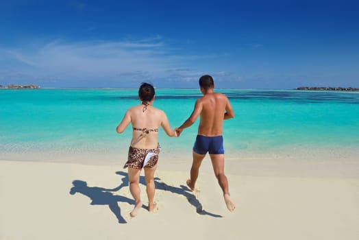 happy young asian couple have fun and romantic time at  summer on beautiful white sand beach