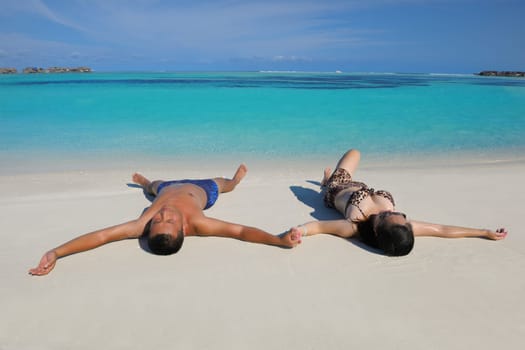 happy young asian couple have fun and romantic time at  summer on beautiful white sand beach