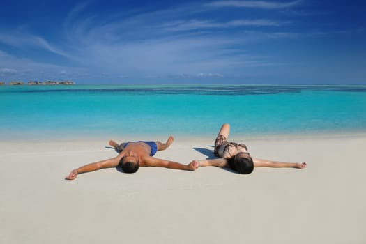 happy young asian couple have fun and romantic time at  summer on beautiful white sand beach