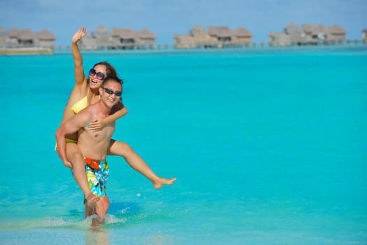 happy young asian couple have fun and romantic time at  summer on beautiful white sand beach