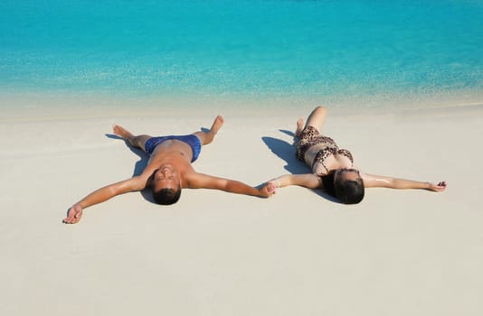 happy young asian couple have fun and romantic time at  summer on beautiful white sand beach