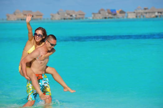 happy young asian couple have fun and romantic time at  summer on beautiful white sand beach