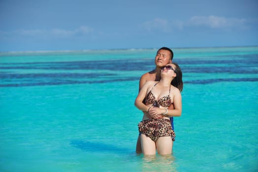 happy young asian couple have fun and romantic time at  summer on beautiful white sand beach