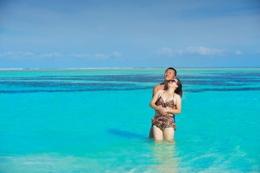 happy young asian couple have fun and romantic time at  summer on beautiful white sand beach