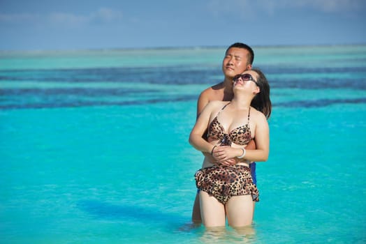happy young asian couple have fun and romantic time at  summer on beautiful white sand beach