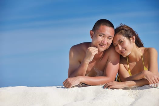 happy young asian couple have fun and romantic time at  summer on beautiful white sand beach