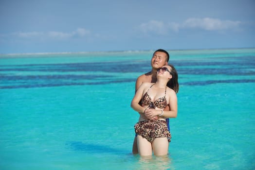 happy young asian couple have fun and romantic time at  summer on beautiful white sand beach