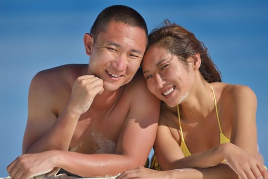 happy young asian couple have fun and romantic time at  summer on beautiful white sand beach