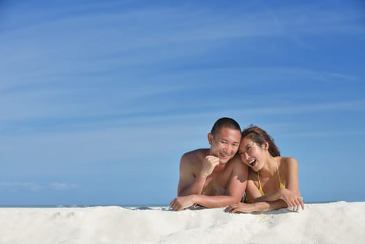 happy young asian couple have fun and romantic time at  summer on beautiful white sand beach