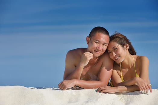 happy young asian couple have fun and romantic time at  summer on beautiful white sand beach