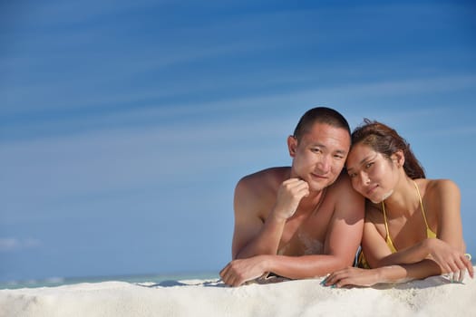 happy young asian couple have fun and romantic time at  summer on beautiful white sand beach