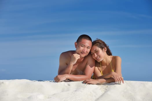 happy young asian couple have fun and romantic time at  summer on beautiful white sand beach