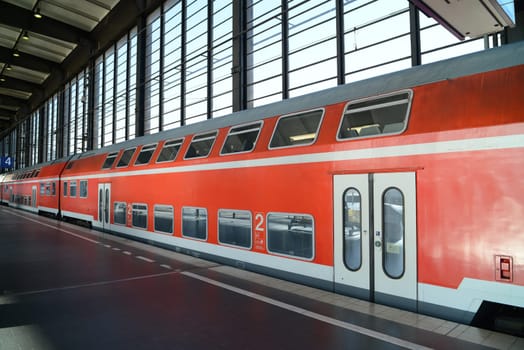 German red double decker train at station in Berlin.