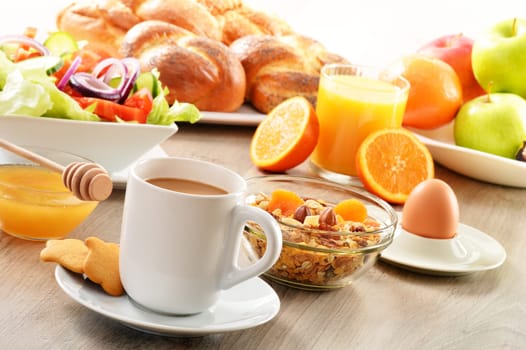 Breakfast including coffee, bread, honey, orange juice, muesli and fruits