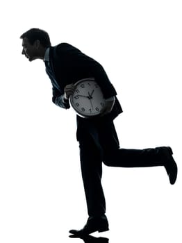 one caucasian businessman holding clock robbing time  in silhouette studio isolated on white background