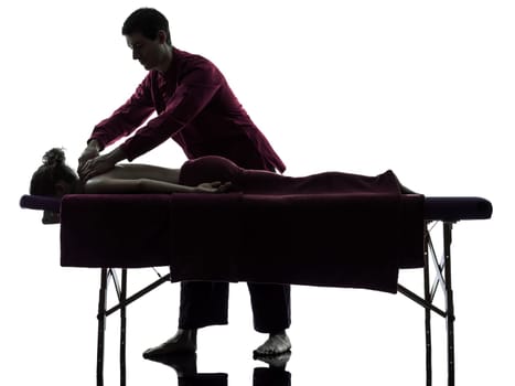 man woman back massage in silhouette studio on white background
