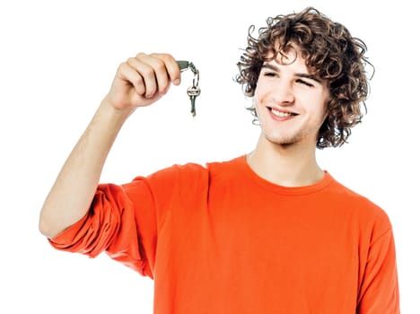 one young man caucasian holding keys portrait  in studio white background