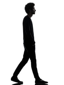 one african handsome young man walking  in silhouette studio isolated on white background