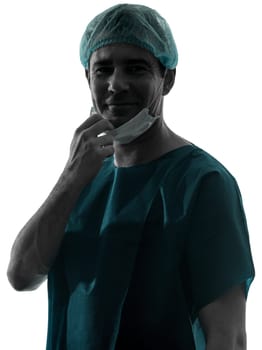 one caucasian doctor surgeon man portrait with face mask medical worker smiling friendly silhouette isolated on white background