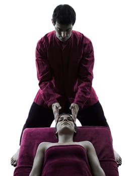 woman receiving head massage in silhouette studio on white background
