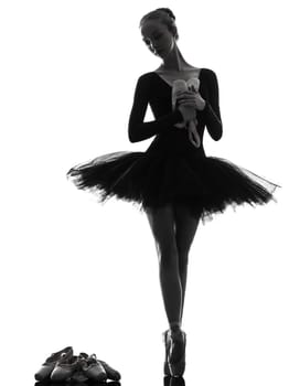 one caucasian young woman ballerina ballet dancer dancing with tutu in silhouette studio on white background