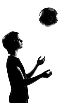 one caucasian young teenager silhouette boy girl tossing soccer football portrait in studio cut out isolated on white background