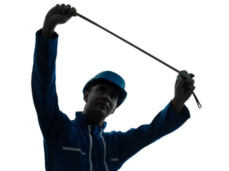 one caucasian man construction worker Tape Measure silhouette in studio on white background