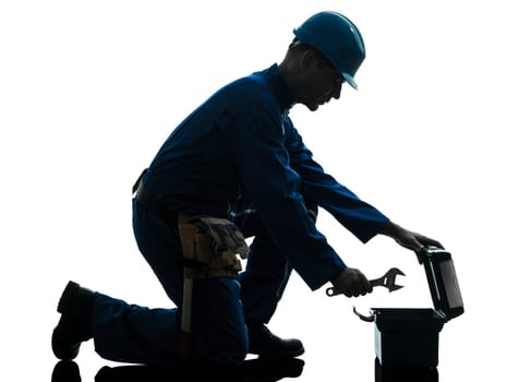 one caucasian repairman worker silhouette in studio on white background