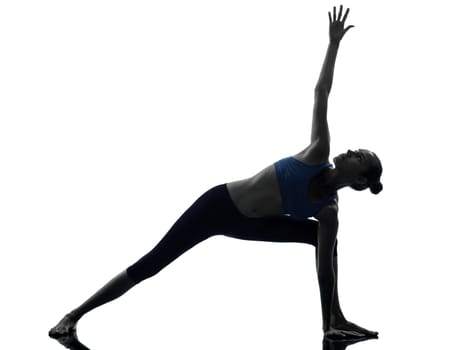 one caucasian woman exercising stretching triangle pose yoga in silhouette studio isolated on white background