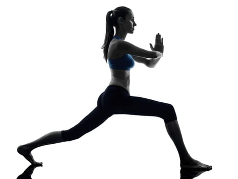 one caucasian woman exercising yoga warrior position in silhouette studio isolated on white background