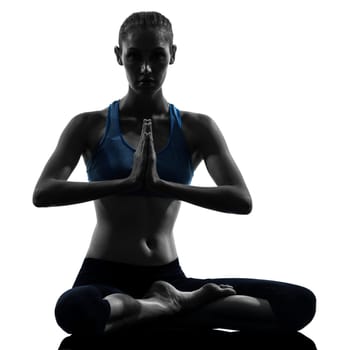 one caucasian woman exercising yoga meditating in silhouette studio isolated on white background