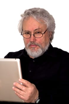 A senior with grey hair is holding a tablet and looking suspicious