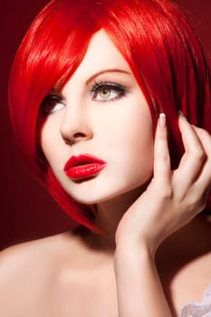 Beautiful young woman with shiny red hair and perfect makeup
