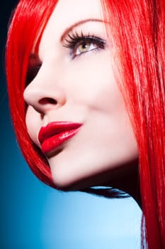 Beautiful young woman with shiny red hair and perfect makeup