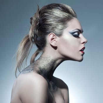 Beautiful young woman with exciting makeup and beautiful hairstyling