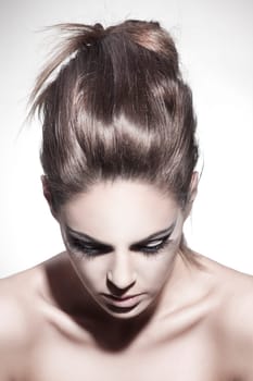 Beautiful young woman with exciting makeup and beautiful hairstyling